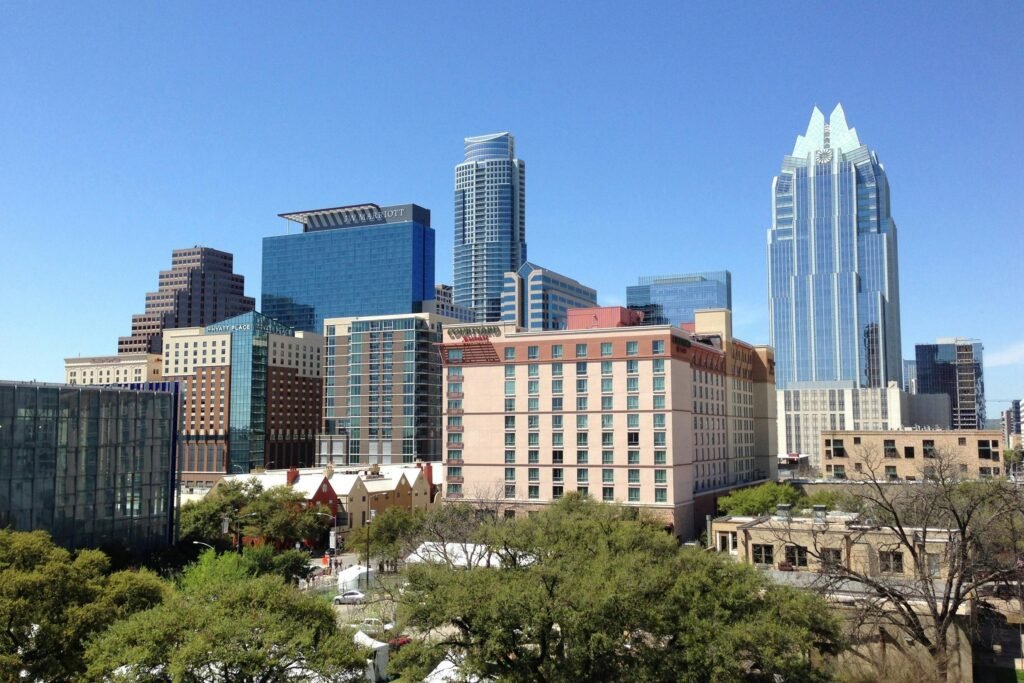 pexels-photo-273204-273204 A vibrant daytime cityscape of downtown Austin, showcasing modern architecture and towering skyscrapers.